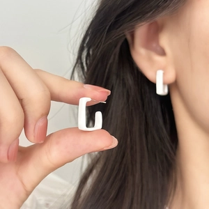 Minimalist white geometric rectangular stud earrings worn by model for daily wear