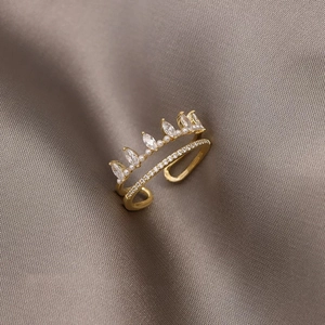 Elegant gold crown open ring featuring marquise zircon and pearls on silk background