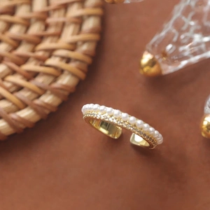 Elegant gold-plated open ring with parallel rows of pearls and cubic zirconia stones