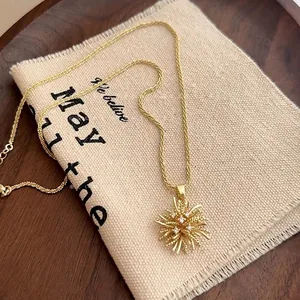 Detail of gold starburst necklace with cubic zirconia on a rustic fabric background