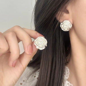 Elegant camellia stud earrings with white enamel petals and silver metal borders for women