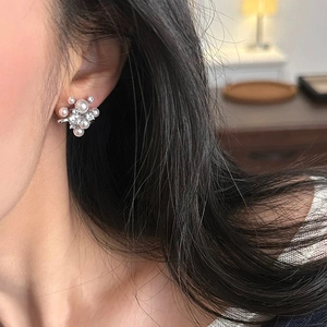 Elegant pearl stud earrings with irregular zircons worn by model for a stylish look