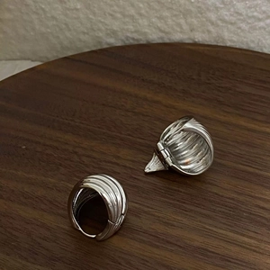 Textured S925 silver hoop earrings with vertical ribbed design on a wooden background