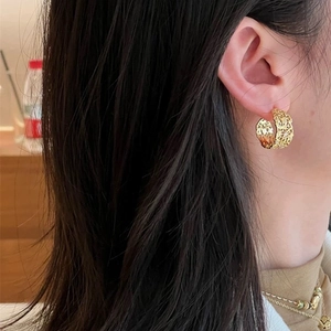 Lace hollow C-shaped gold earrings with zircon on model showing a French vintage style