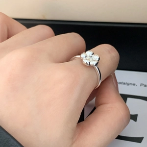 Exquisite silver flower ring with cubic zirconia center and textured petals on a thin band