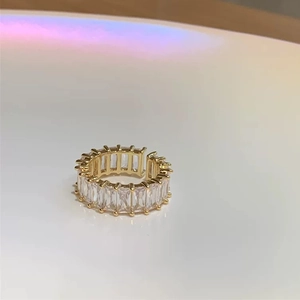 Elegant gold adjustable ring with sparkling rectangular zircons in a full row setting
