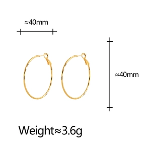 Close-up of 40mm golden hoop earrings with slim tube design and latch back closure