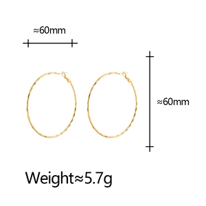 Detail view of 60mm large geometric hoop earrings with hammered texture and 5.7g weight