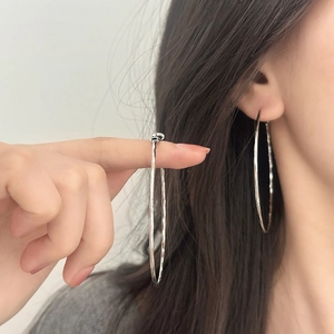 Silver large hoop earrings with hammered texture shown on model for a minimalist style