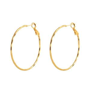 Minimalist large golden hoop earrings with polished metal finish on white background