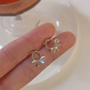 Elegant gold bow earrings with cat eye stones and sparkling cubic zirconia rings