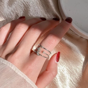Three-layer silver star and moon ring with micro-pave crystals on silk background