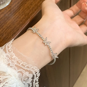 Minimalist silver butterfly bracelet with sparkling cubic zirconia on a model's wrist