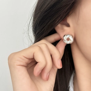 Elegant twisted knot silver stud earrings for women with brushed metal finish and 3D design
