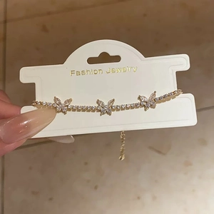 Detail of gold-plated butterfly bracelet featuring sparkling cubic zirconia and adjustable chain