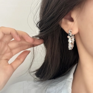 Irregular textured silver C-shaped hoop earrings with a crushed metal finish for women