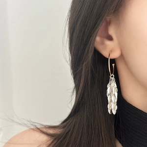 Silver leaf tassel earrings with gold hoop on model, elegant minimalist design for women