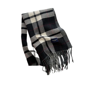 Classic British plaid cashmere scarf with tassels in black, white, and grey with red accents