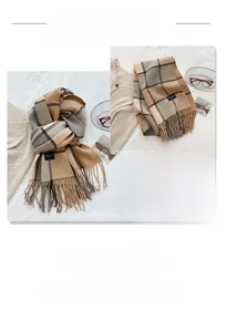 Detail of plaid tassel scarf with soft cashmere-like texture and earthy color tones