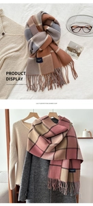 Detail of classic plaid imitation cashmere scarves with elegant tassels and soft texture