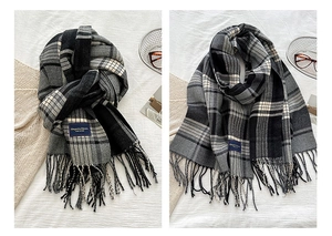 Close-up of classic plaid cashmere-like scarf showing fringe and Elegance woven label