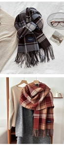 Detail of soft checkered scarves with fringes and elegant brand labels in cozy setting