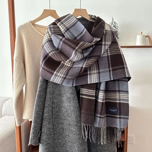 Classic checkered cashmere scarf with blue and brown stripes, hanging with fringe details