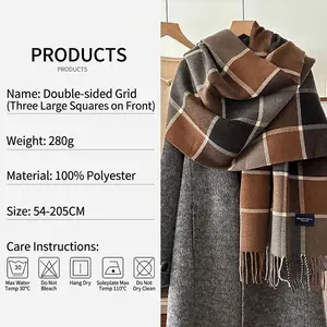 Classic plaid winter scarf with fringe in brown and grey tones draped over a grey wool coat