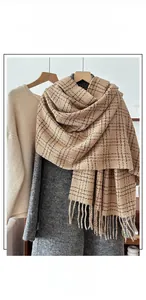 Detailed macro view of the checkered scarf texture with elegant fringed edges and thick yarn
