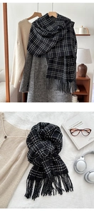 Detailed view of soft black and white checkered scarf with long fringe tassels
