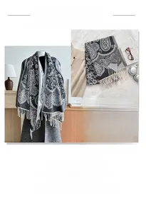 Detail of grey paisley pattern scarf with fringe and soft cashmere-like knit texture