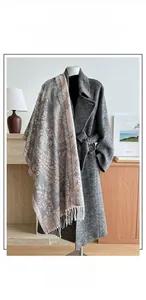 Close-up of cotton linen shawl featuring paisley patterns and fringe tassels in grey pink