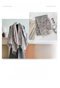 Detail view of the paisley pattern and tassel fringe on gray and pink winter scarf