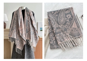 Detail of grey-pink paisley scarf showing intricate floral patterns and soft tassel edges