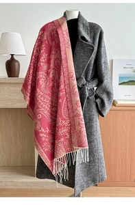 Detail view of ethnic paisley shawl with pink and orange jacquard and white fringes