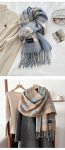 Detail of blue and coffee plaid cashmere-like scarves with fringe and elegant brand label