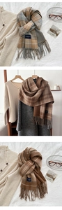 Close-up of thick plaid scarf featuring soft fringe tassels and classic woven textures