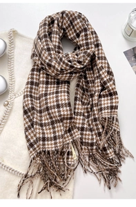 Detail of vintage plaid scarf with fringe edge on a soft knitted background