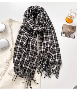 Close-up of the vintage plaid scarf with fringed edges and soft cashmere-like texture