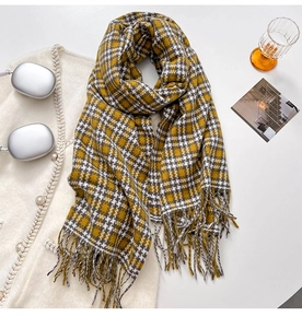 Detail of yellow and grey plaid scarf with soft fringe edges and thick cashmere texture