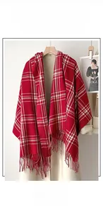 Close-up of red and white checkered scarf with long tassels and soft fabric texture