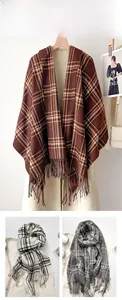 Detail of plaid scarves with tassels in brown, beige and gray soft cashmere feel