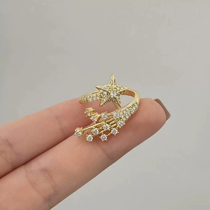 Elegant gold-tone star ring with cubic zirconia comet tail in polished open-band design