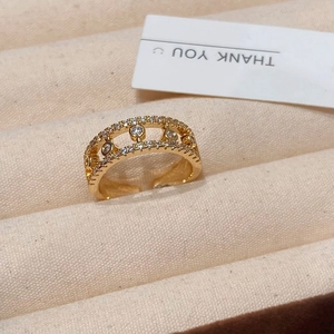 Double layered gold plated ring with round clear zircon stones in a jewelry box