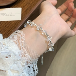 Minimalist silver beaded bracelet with clear irregular crystals on a woman's wrist