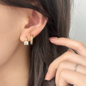 Minimalist gold zircon earrings set with silver twisted rope ring on female model