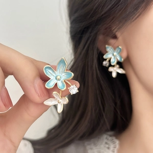 Elegant French style blue and white floral stud earrings with gold trim and zircon accents