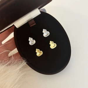 Elegant gold and silver gourd stud earrings with textured hammer finish in a gift box