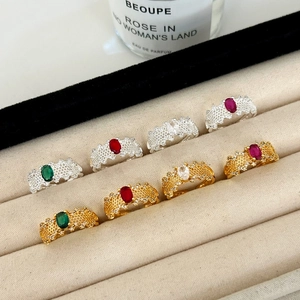 Elegant hollow lace open ring set with red and green oval gemstones in gold and silver