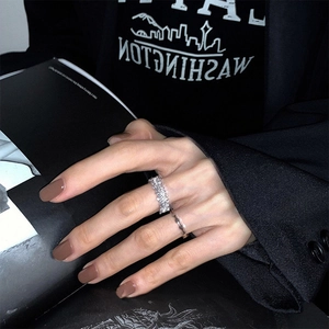 Close-up of a silver zircon two-piece ring set worn on hand with a modern street style